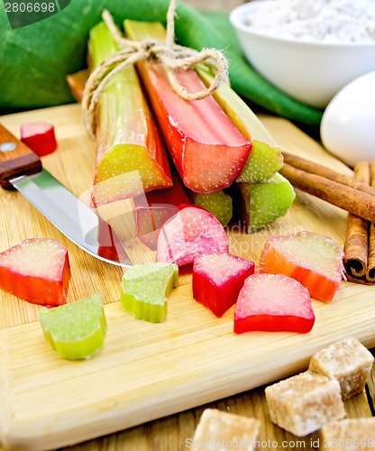 Image of Rhubarb with sugar and knife on board