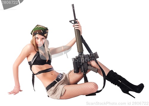 Image of Pretty woman with sniper rifle on floor