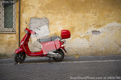 Image of Bright shiny red Vespa scooter