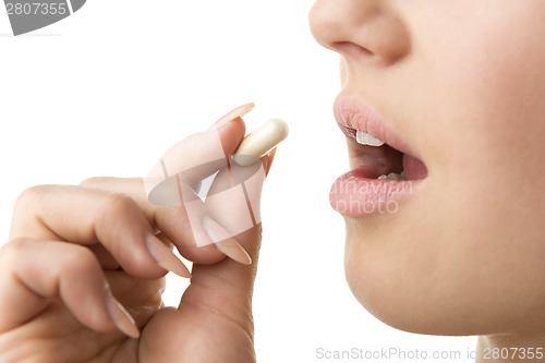 Image of closeup taking pill