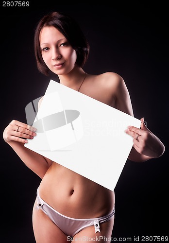 Image of Attractive sexy nude woman holding blank banner