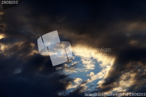 Image of Storm clouds on sunset sky