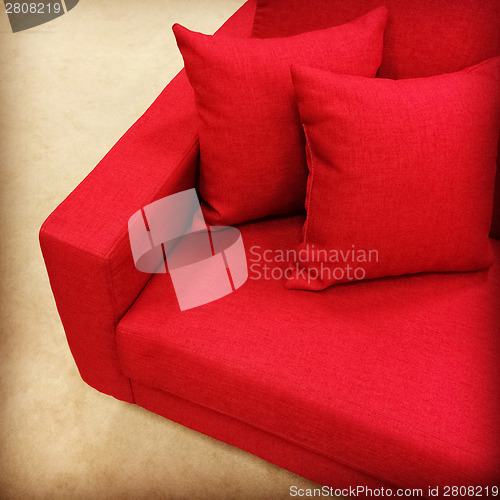 Image of Red sofa with cushions