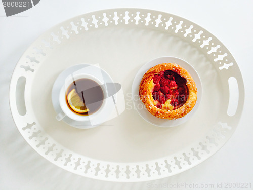 Image of Tray with raspberry pastry and cup of tea