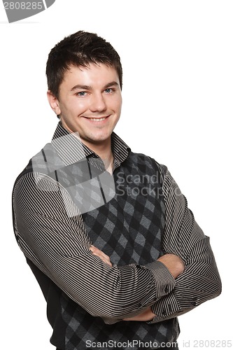 Image of Portrait of young smiling confident man with folded hands