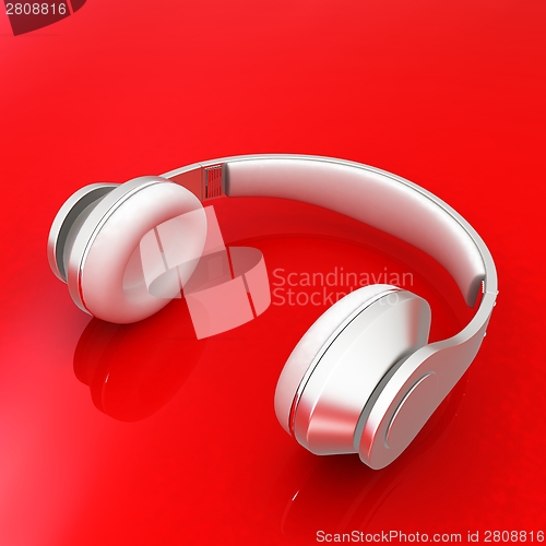 Image of White headphones isolated on a red background 