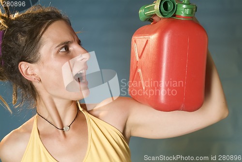 Image of woman looks at petrol can