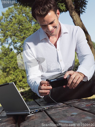 Image of A smiling man with laptop