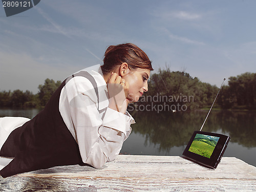 Image of a woman with laptop in park