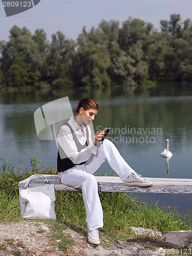 Image of woman using PDA outdoors