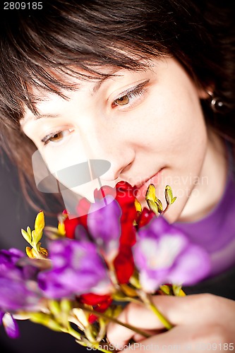 Image of beautiful woman with purple flowers