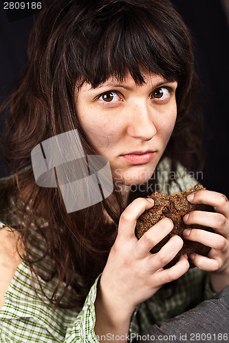 Image of beggar woman with a piece of bread 