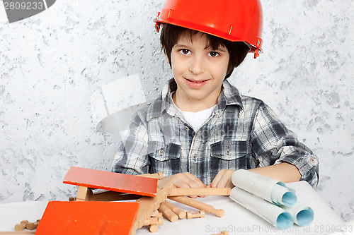 Image of boy plans to build a house