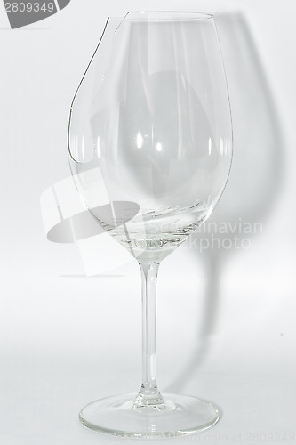 Image of Broken clear wineglass with sharp glass fragments inside