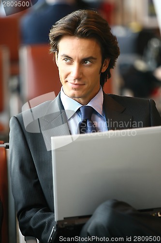 Image of businessman sitting in the airport b