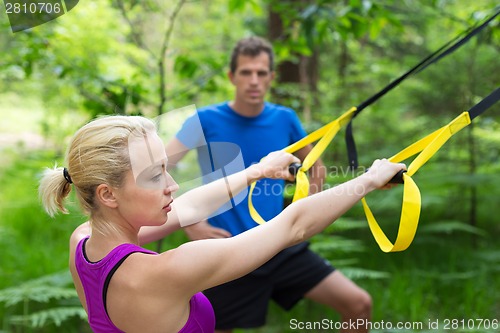 Image of Training with fitness straps outdoors.