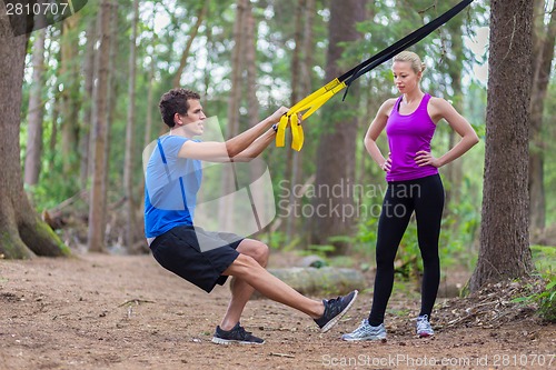 Image of Training with fitness straps outdoors.