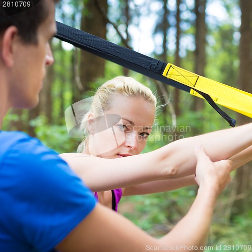 Image of Training with fitness straps outdoors.