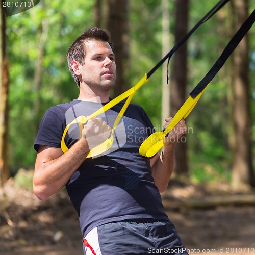 Image of Training with fitness straps outdoors.