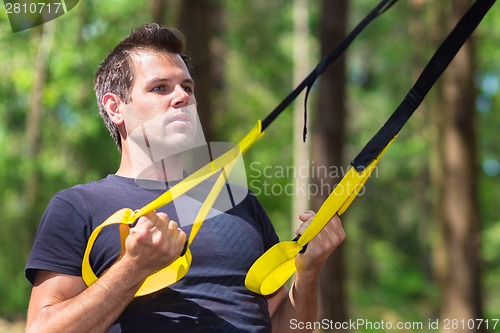 Image of Training with fitness straps outdoors.