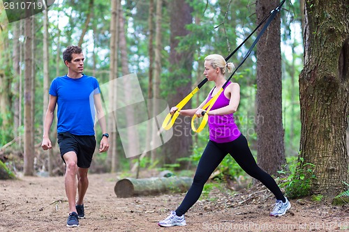 Image of Training with fitness straps outdoors.