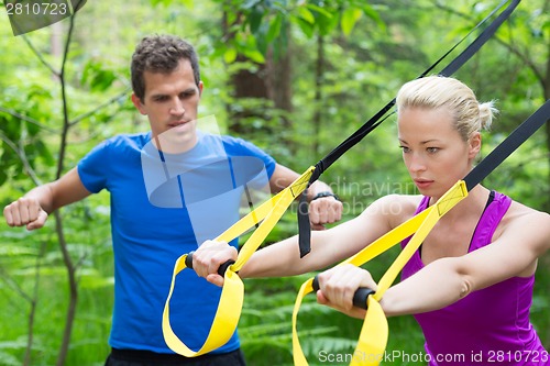 Image of Training with fitness straps outdoors.