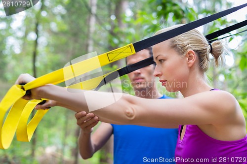 Image of Training with fitness straps outdoors.