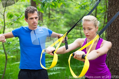 Image of Training with fitness straps outdoors.