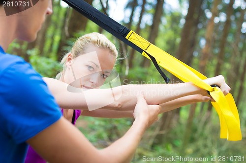 Image of Training with fitness straps outdoors.