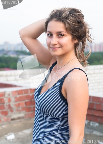 Image of Attractive young woman on roof