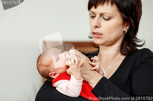 Image of Loving mother embracing her baby