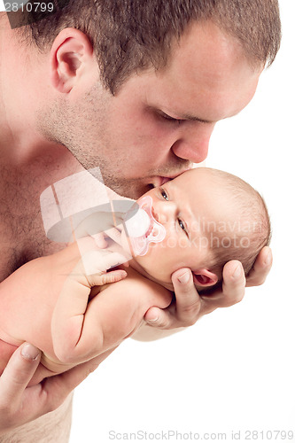 Image of Loving father kissing his baby