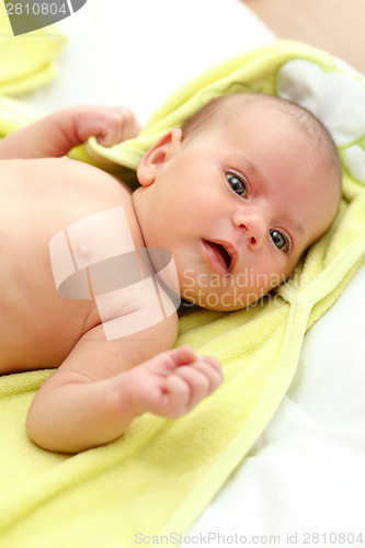 Image of infant wrapped in a towel after bath