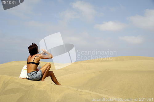 Image of Woman drinking in desert