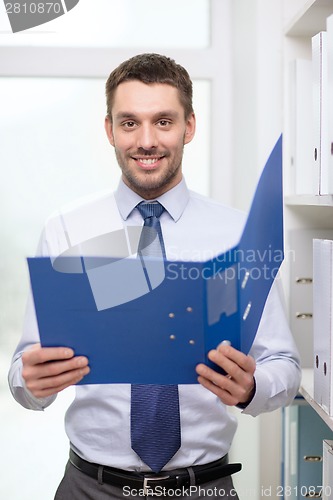 Image of businessman with folder at office