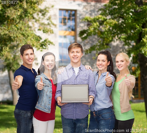 Image of smiling students with laptop computer