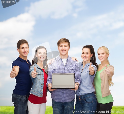 Image of smiling students with laptop computer