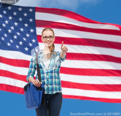 Image of student with laptop bag showing thumbs up