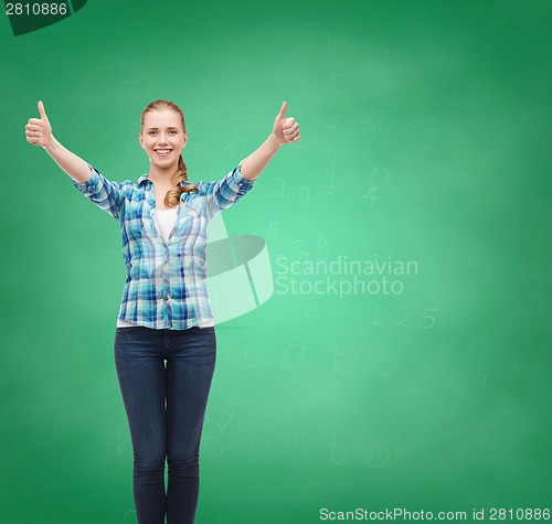 Image of smiling girl in casual clothes showing thumbs up