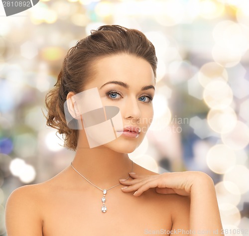 Image of woman wearing shiny diamond pendant