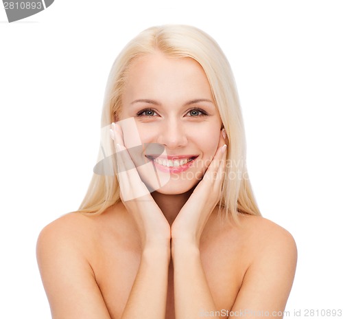 Image of face of beautiful woman touching her face skin