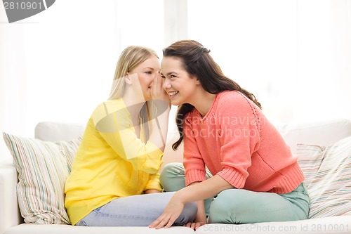 Image of one girl telling another secret