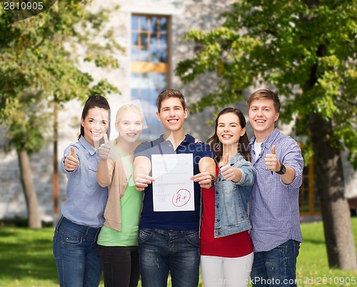 Image of group of students showing test and thumbs up