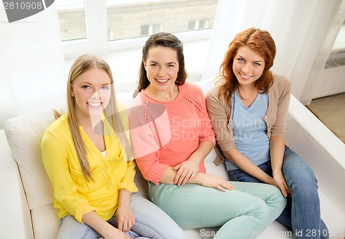 Image of three girlfriends having a talk at home