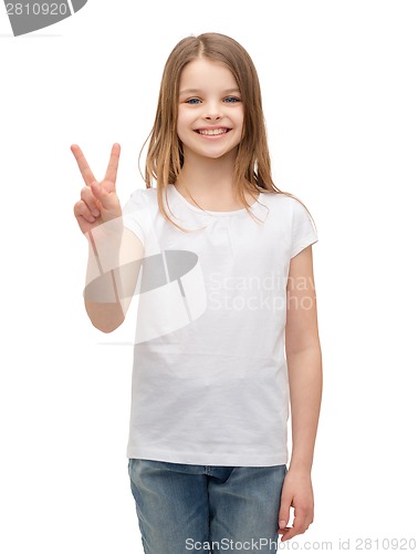 Image of little girl in white t-shirt showing peace gesture