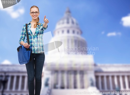 Image of student with laptop bag showing thumbs up
