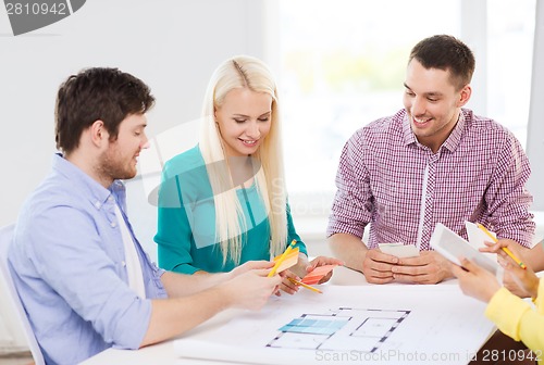 Image of smiling interior designers working in office