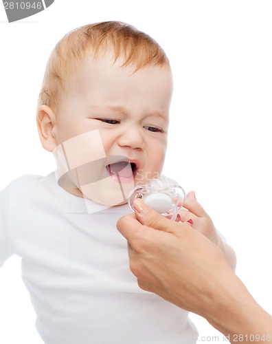 Image of crying baby with dummy