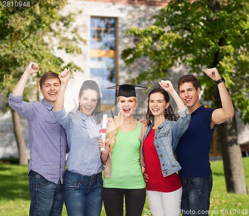 Image of group of standing smiling students with diploma