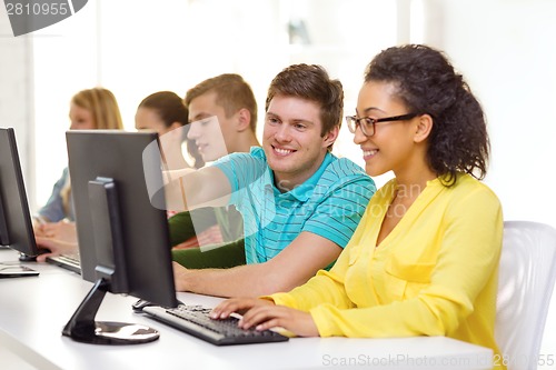 Image of smiling students in computer class at school